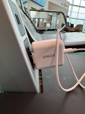 A US style plug barely holding on with its connection to a socket at Vancouver Airport