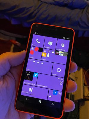 A Microsoft Lumia 640 running either Windows Phone 8 or Windows Phone 10, depicting a home screen full of tiles.