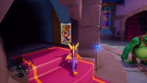 A screenshot of the Spyro Reignited Trilogy version of Spyro 2. Spyro looks at a poster for Spyro Reignited Trilogy.