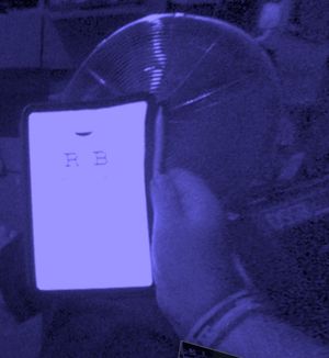 An iPad Mini with an optician's eye chart viewed through the Steam Frame. Most of the screen is completely whited out, save the largest two letters of the chart